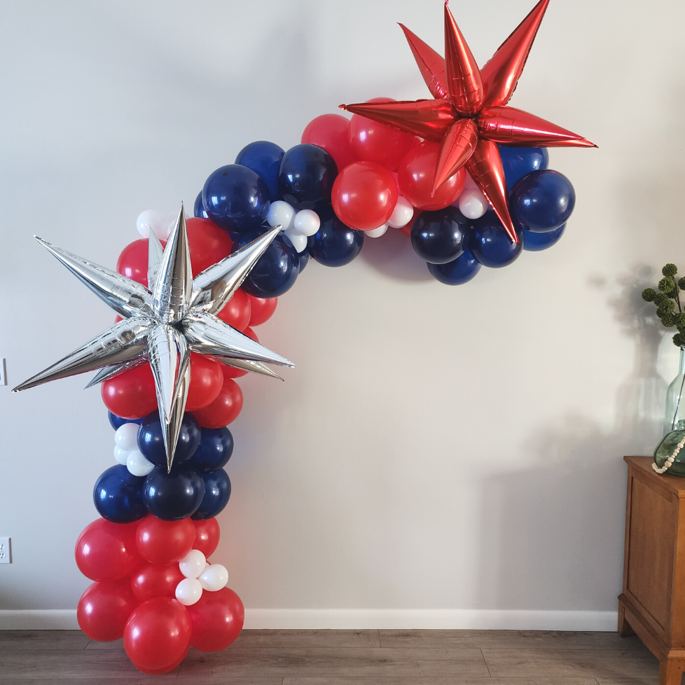 Red, white and blue balloon garland with silver star party decoration. 